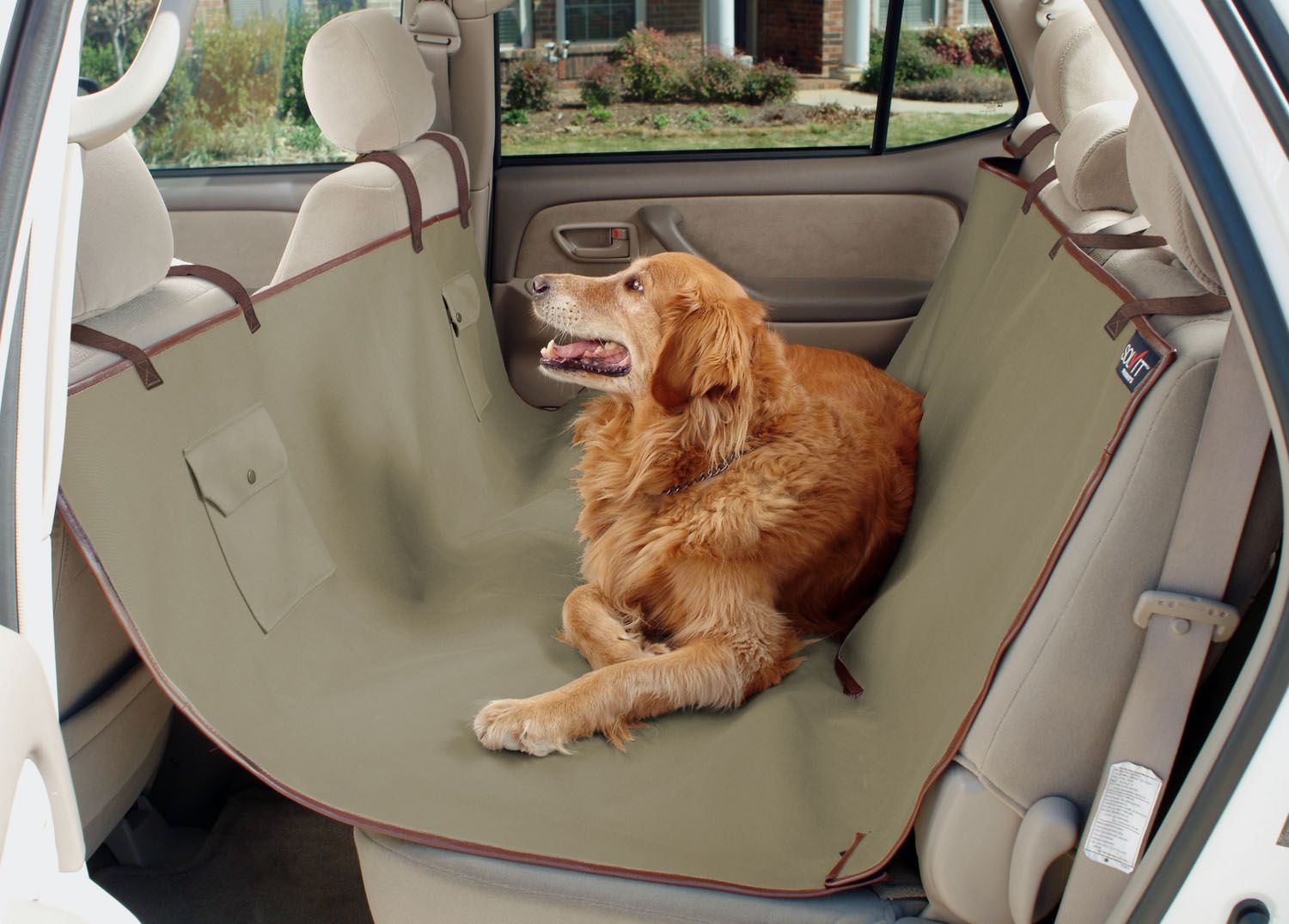 arabanın arka koltuğunda örtü üzerinde yatan Golden Retriever cinsi köpek